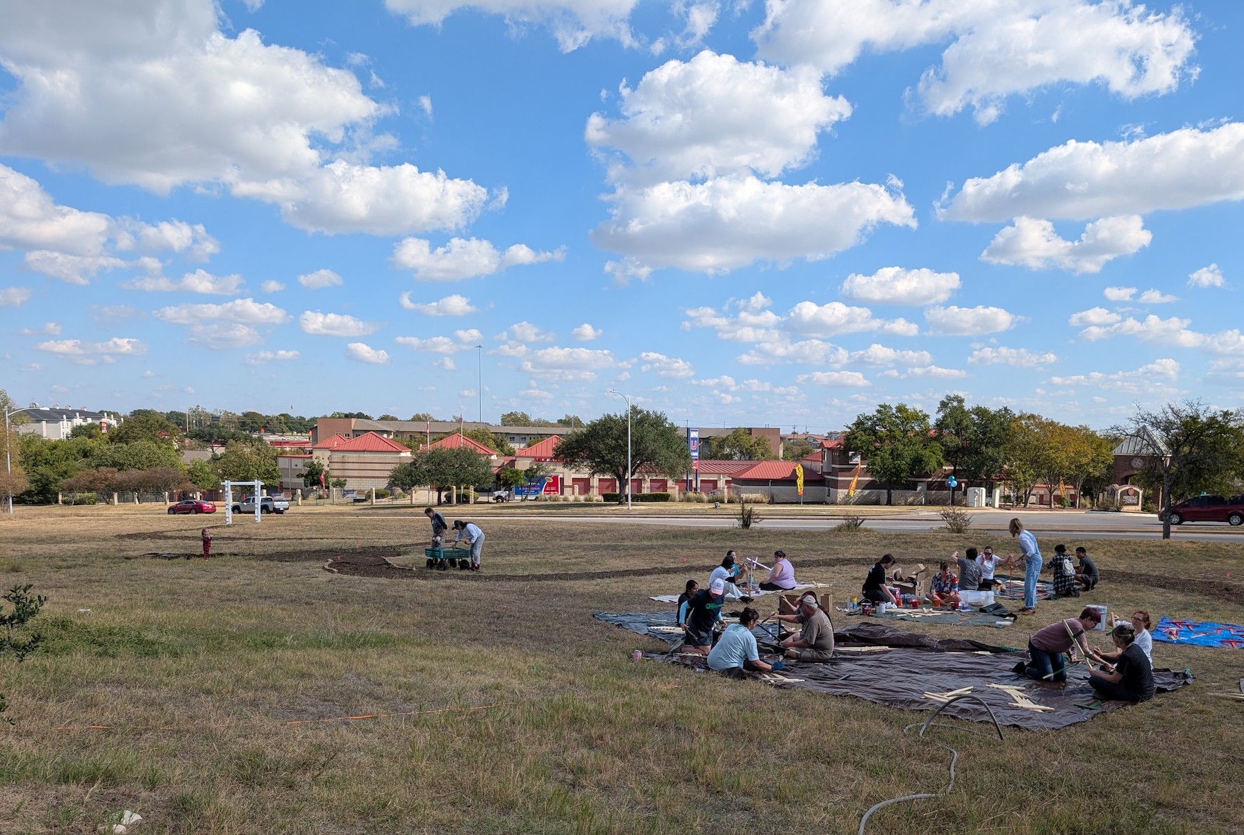 Church members painting crosses in the yard