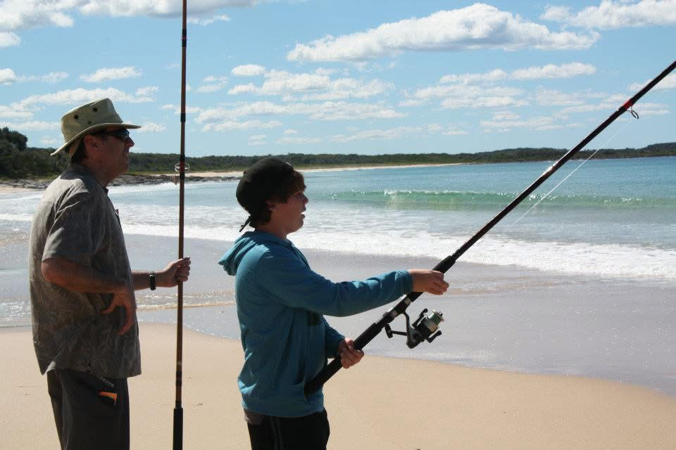 Casting a fishing rod on a sunny Australian beach