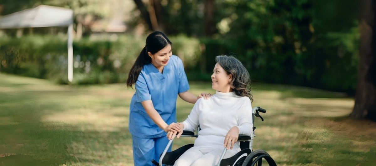 Family and caregiver supporting an elderly parent