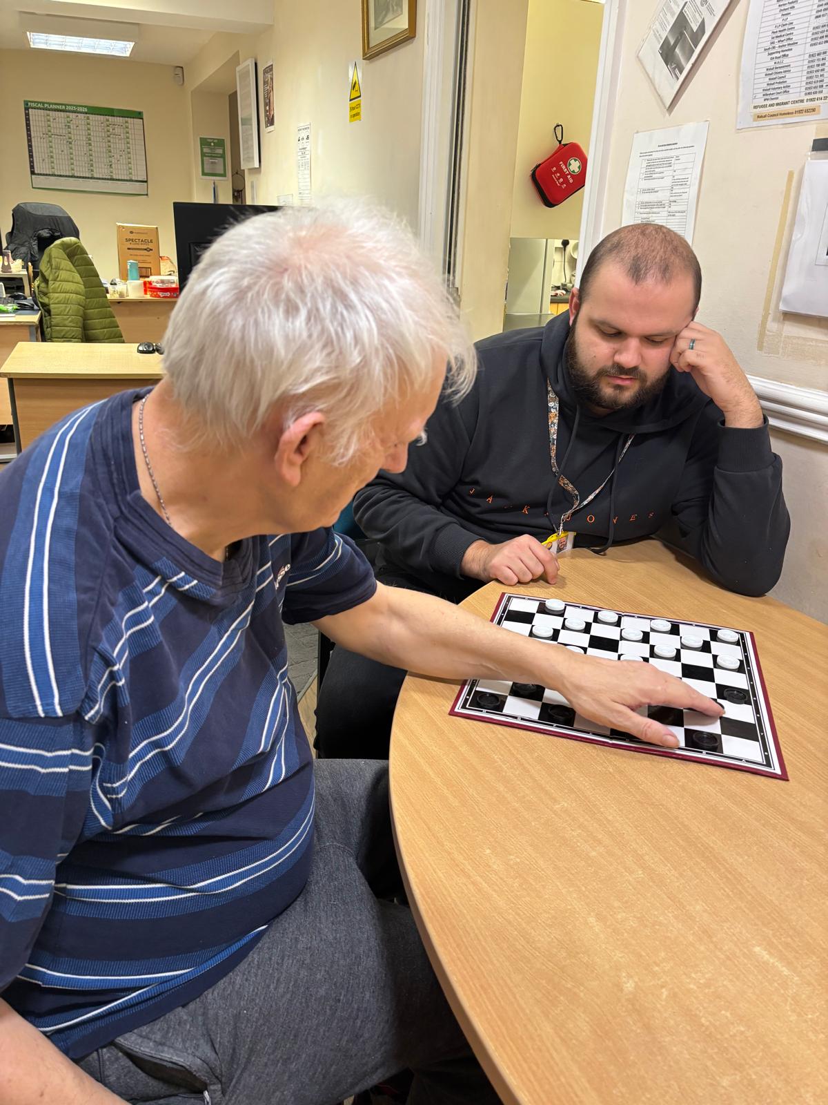 Resident Paul, playing draughts with Sam